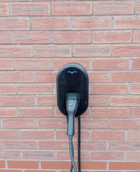 VCHRGD charger on a red-brick new-build