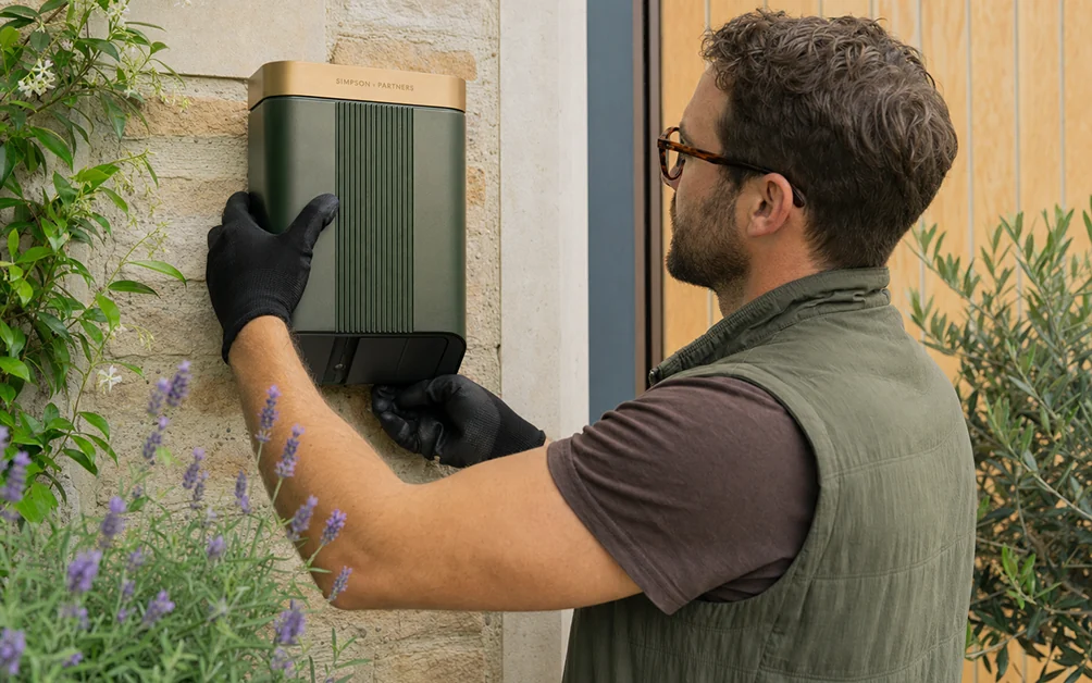 Ridgeway Electrical installer mounting a Simpson & Partners charge point on a stone wall